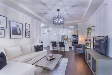 St.Louis townhouse for rent - a living room with a white couch and a tv