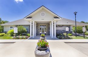 Ellisville apartment for rent - the front of a building with flowers in front of it at Aventura at Towne Centre, Missouri