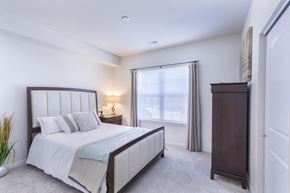 Ellisville apartment for rent - a bedroom with a bed and a dresser and a window at Aventura at Towne Centre, Ellisville, 63011