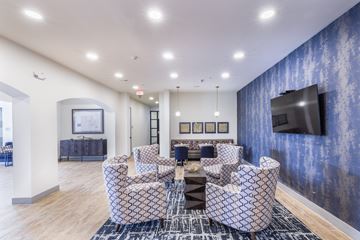 Chesterfield apartment for rent - a living room with couches and a table and a television