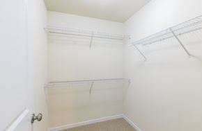 St. Louis townhouse for rent - a spacious closet in a small room with shelves and a glass door