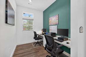 St. Louis apartment for rent - A room with two chairs and two desks with computers.