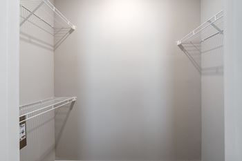 Empty white shelves in a room.