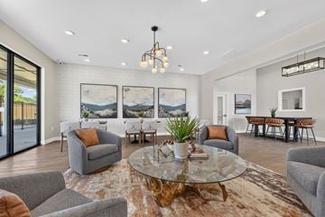 St. Peters apartment for rent - A living room with a glass table and grey couches.