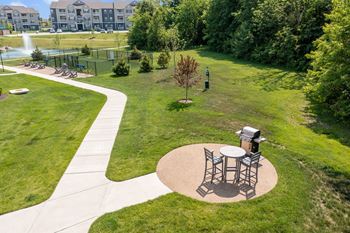 A park with a picnic table and a walking path.
