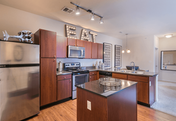 A kitchen with wooden cabinets and stainless steel appliances