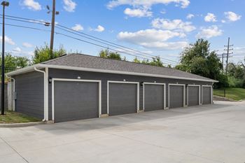 A garage with four garages on the side of a street
