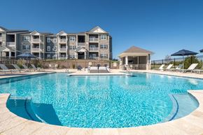 Lake St Louis apartment for rent - a swimming pool with an apartment building in the background  at Aventura at Hawk Ridge, Lake St Louis