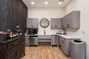 Chesterfield apartment for rent - A kitchen with wooden cabinets and a round mirror above the sink.