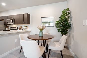 A dining area with a table and three chairs
