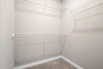 Empty white shelves in a room.