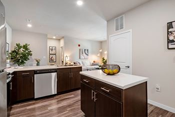A kitchen with brown cabinets and a white countertop.