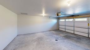 Sturgeon Bay apartment for rent - A spacious garage with a concrete floor and a white wall.