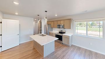 Sturgeon Bay apartment for rent - A kitchen with a white island and wooden cabinets.