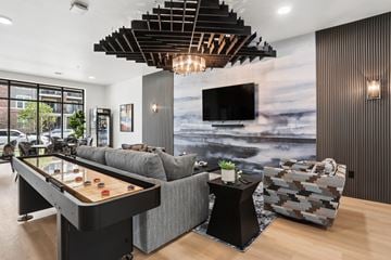 Hobart apartment for rent - A modern living room with a pool table and a couch.