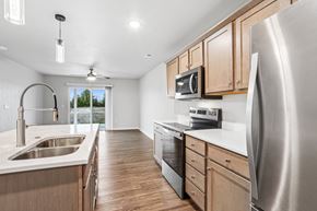 Sturgeon Bay apartment for rent - A modern kitchen with wooden cabinets and stainless steel appliances.
