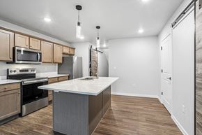 Sturgeon Bay apartment for rent - A kitchen with a white countertop and wooden cabinets.
