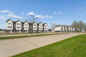 De Pere townhouse for rent - A row of houses with a tree in front of the first house.