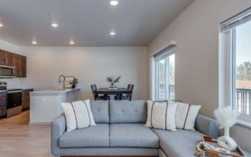 Green Bay apartment for rent - a living room with a couch and a kitchen with a table
