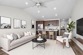 De Pere townhouse for rent - A living room with a white couch, a black coffee table, and a ceiling fan.