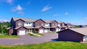 Green Bay apartment for rent - A large, modern house with a driveway and garage.