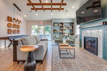 Green Bay apartment for rent - A modern living room with a grey couch and a wooden coffee table.