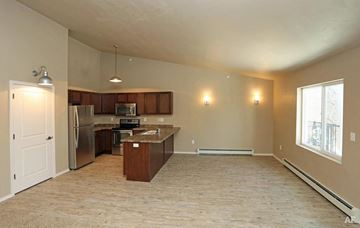 Howard apartment for rent - A kitchen with a refrigerator, microwave, and oven is shown in this image.