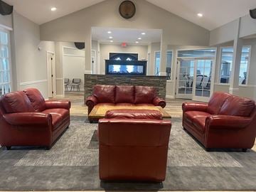 St Peters apartment for rent - a large living room with leather furniture and a fireplace