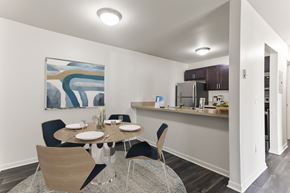 Kalamazoo apartment for rent - A dining room with a table set for two and a painting on the wall.