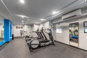 Grand Rapids apartment for rent - a gym with cardio machines and weights in a building
