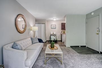Grand Rapids apartment for rent - a living room with a white couch and a coffee table
