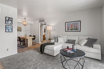 Kalamazoo apartment for rent - A living room with a white couch and a coffee table.