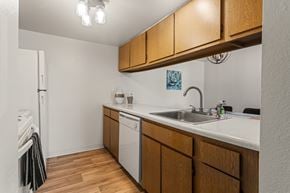 Kalamazoo apartment for rent - A kitchen with wooden cabinets and a white countertop.