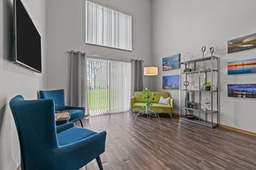Wyoming apartment for rent - A living room with a blue chair and a green couch.