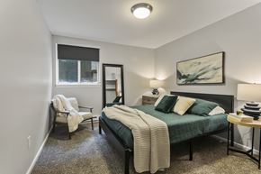 Grand Rapids apartment for rent - a bedroom with a bed and a chair and a window