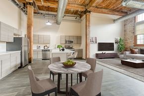 Muskegon apartment for rent - A modern kitchen with a dining table set for four.
