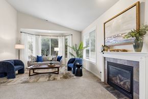 Kennewick apartment for rent - A living room with a fireplace and a painting on the wall.