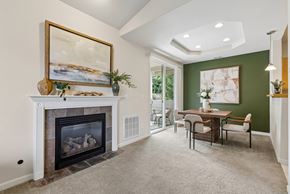 Kennewick apartment for rent - A living room with a fireplace and a painting on the wall.