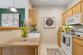 Kennewick apartment for rent - A kitchen with wooden cabinets and a white oven.
