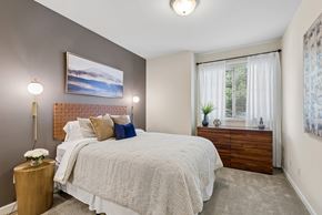 Kennewick apartment for rent - A bedroom with a large bed and a painting on the wall.