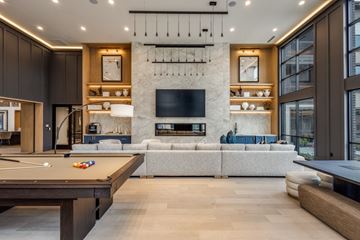 Mckinney apartment for rent - A modern living room with a pool table and a fireplace.