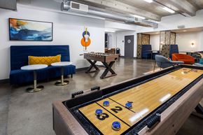 Sacramento apartment for rent - a game room with a shuffleboard table and a foosball