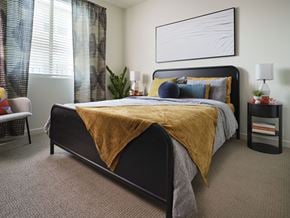 Murrieta apartment for rent - A bedroom with a large bed and a yellow blanket.