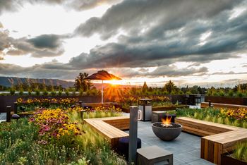 Expansive rooftop lounge with fire pits and panoramic mountain views