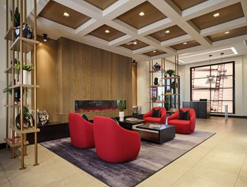 Phoenix apartment for rent - a living room with red chairs and a fireplace