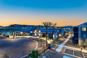 Las Vegas apartment for rent - A modern residential area with a roundabout and palm trees.