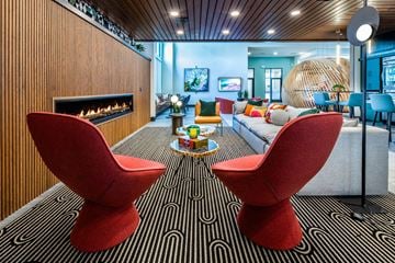 Las Vegas apartment for rent - a living room with a couch and chairs in front of a fireplace