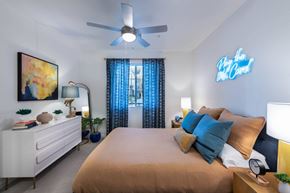 Las Vegas apartment for rent - a bedroom with a large bed and a ceiling fan