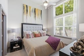 Frisco apartment for rent - A bedroom with a large bed and a painting above it.