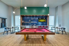 Henderson apartment for rent - a pool table in a room with a bar and tables